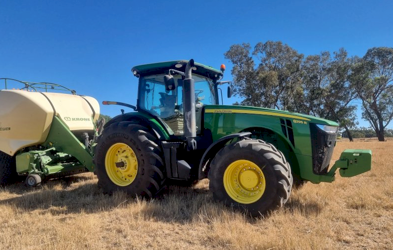 2015 John Deere 8295R Tractor with a 2017 Krone 1290 HDP 11 XC Big Pack Baler