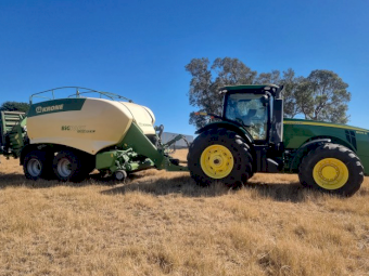 2015 John Deere 8295R Tractor with a 2017 Krone 1290 HDP 11 XC Big Pack Baler