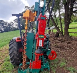 McCormick Tractor with FEL and Munro Post Driver