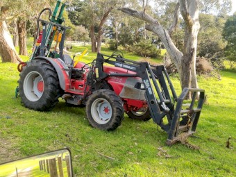 McCormick Tractor with FEL and Munro Post Driver