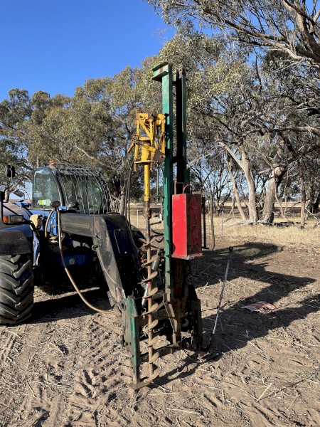 Munro post driver with manitou quick hitch.